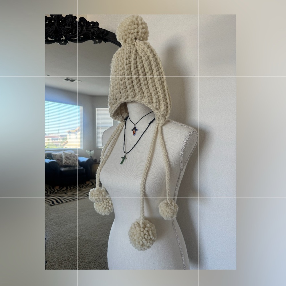 Handmade Crochet Beanie with pompom accents and ear covers.